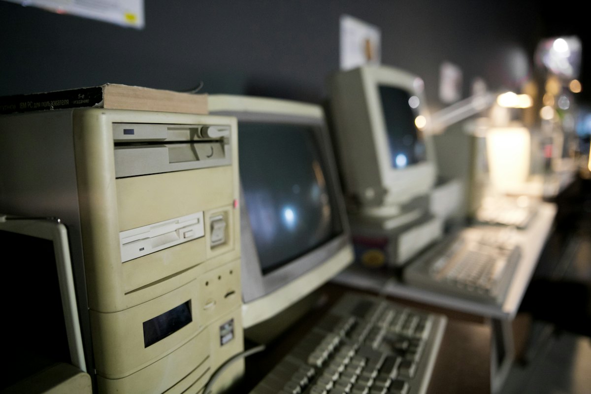 Rows of old beige office computers with CRT monitors